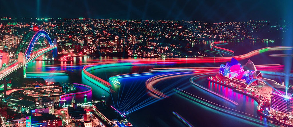 Aerial view of the vibrantly lit-up Sydney Harbour during Vivid Sydney
