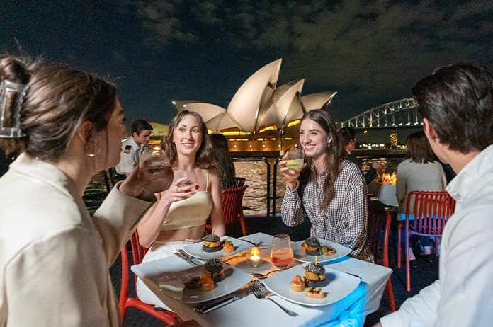 Guests enjoying the food and drinks aboard the Magistic dinner cruise