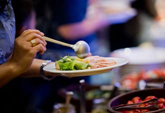 Guests helping themselves to the buffet spread aboard the Magistic dinner cruise on Sydney Harbour