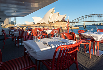 Al fresco dining space on the Magistic cruises with the backdrop of Sydney's iconic attractions
