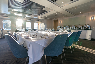 Air-conditioned dining saloon with panoramic windows on the Magistic cruise.