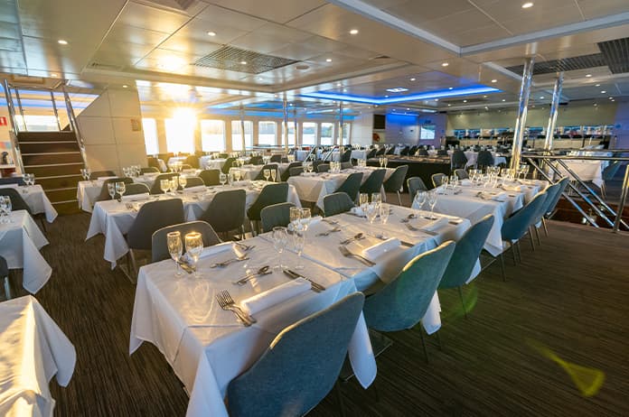 Dining saloon featuring panoramic windows on the Magistic Lunch Cruise