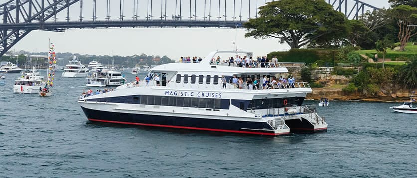Guests enjoying Australia Day from the decks of the Magistic Two, cruising past the Harbour Bridge